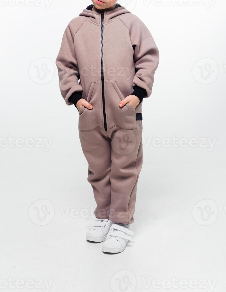 Child wearing a taupe zip-up jumpsuit photo