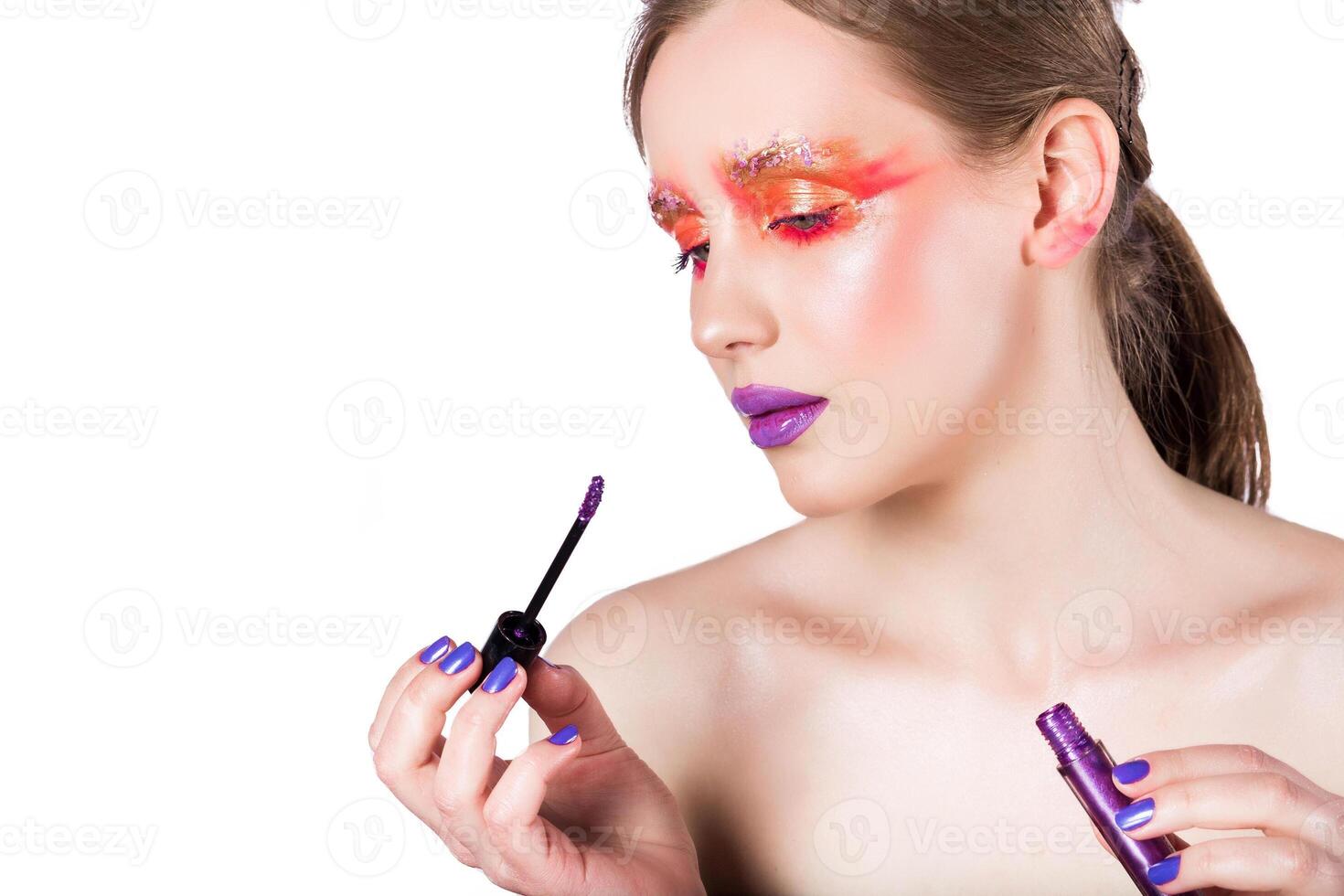 Woman Applying Vibrant Purple Lip Gloss photo