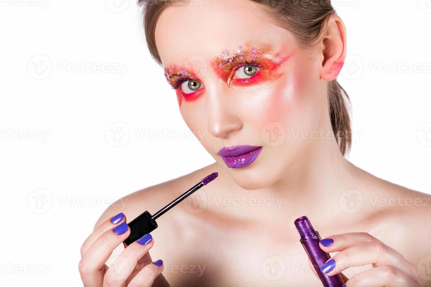 Applying Bold Purple Lip Gloss photo