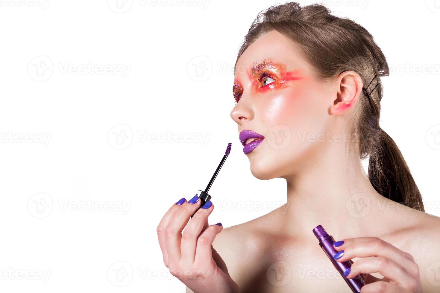 Woman Applying Purple Lip Gloss photo