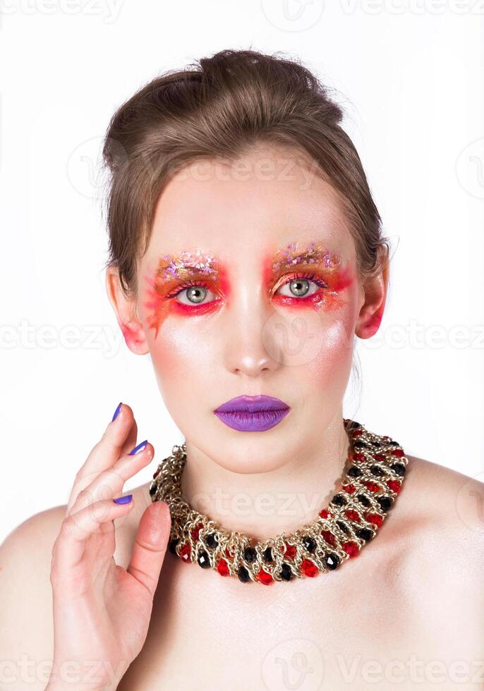 Elegant Woman with Artistic Makeup and Necklace photo
