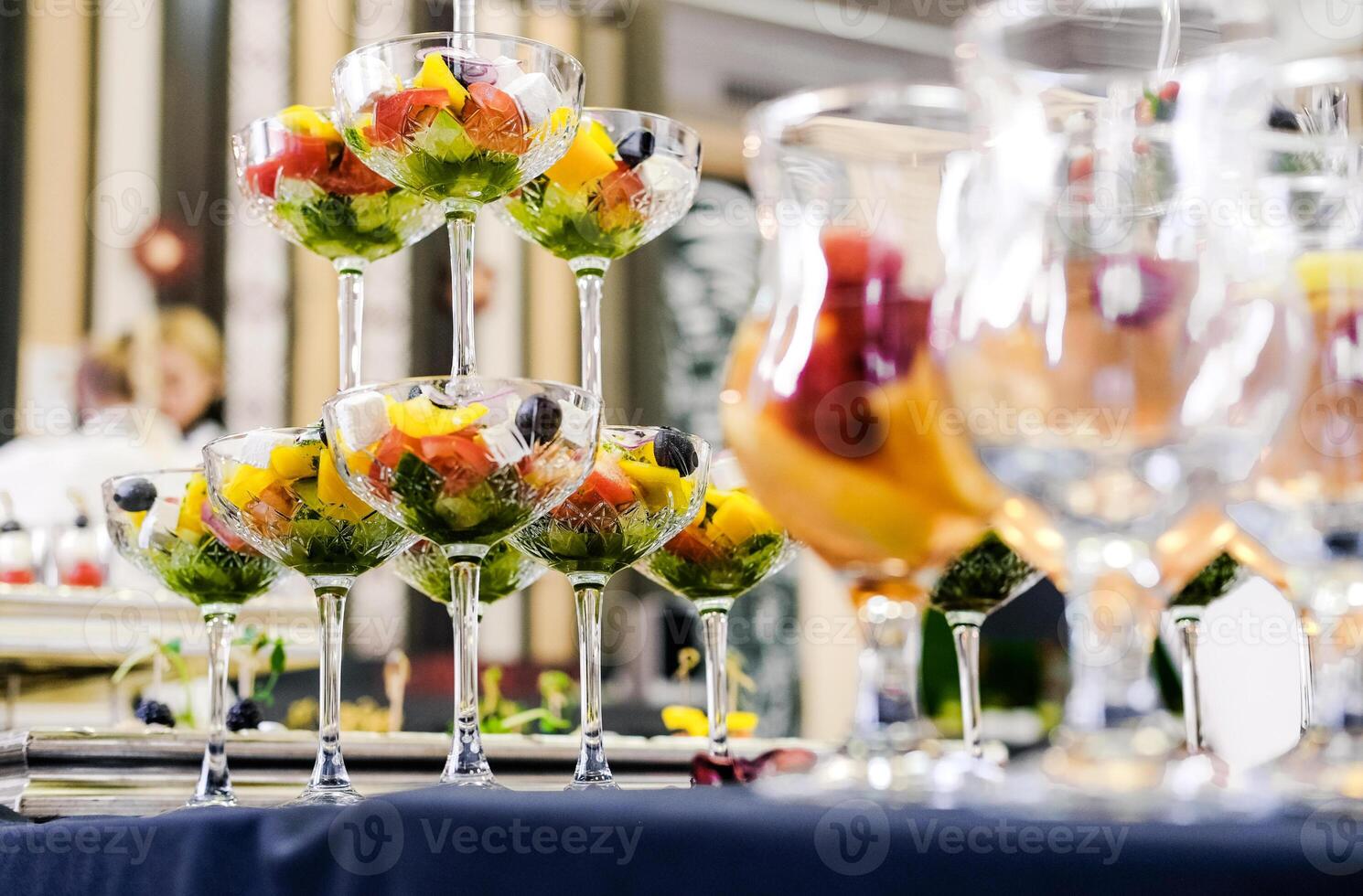 Glasses with Vegetable Salad on Buffet Table photo