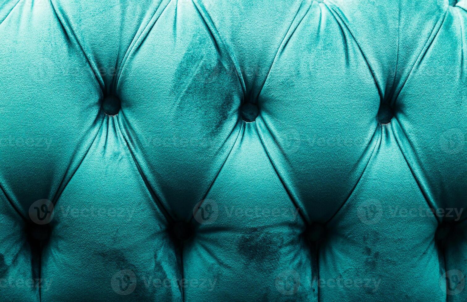 Turquoise Velvet Tufted Sofa Close-Up with Elegant Pattern photo