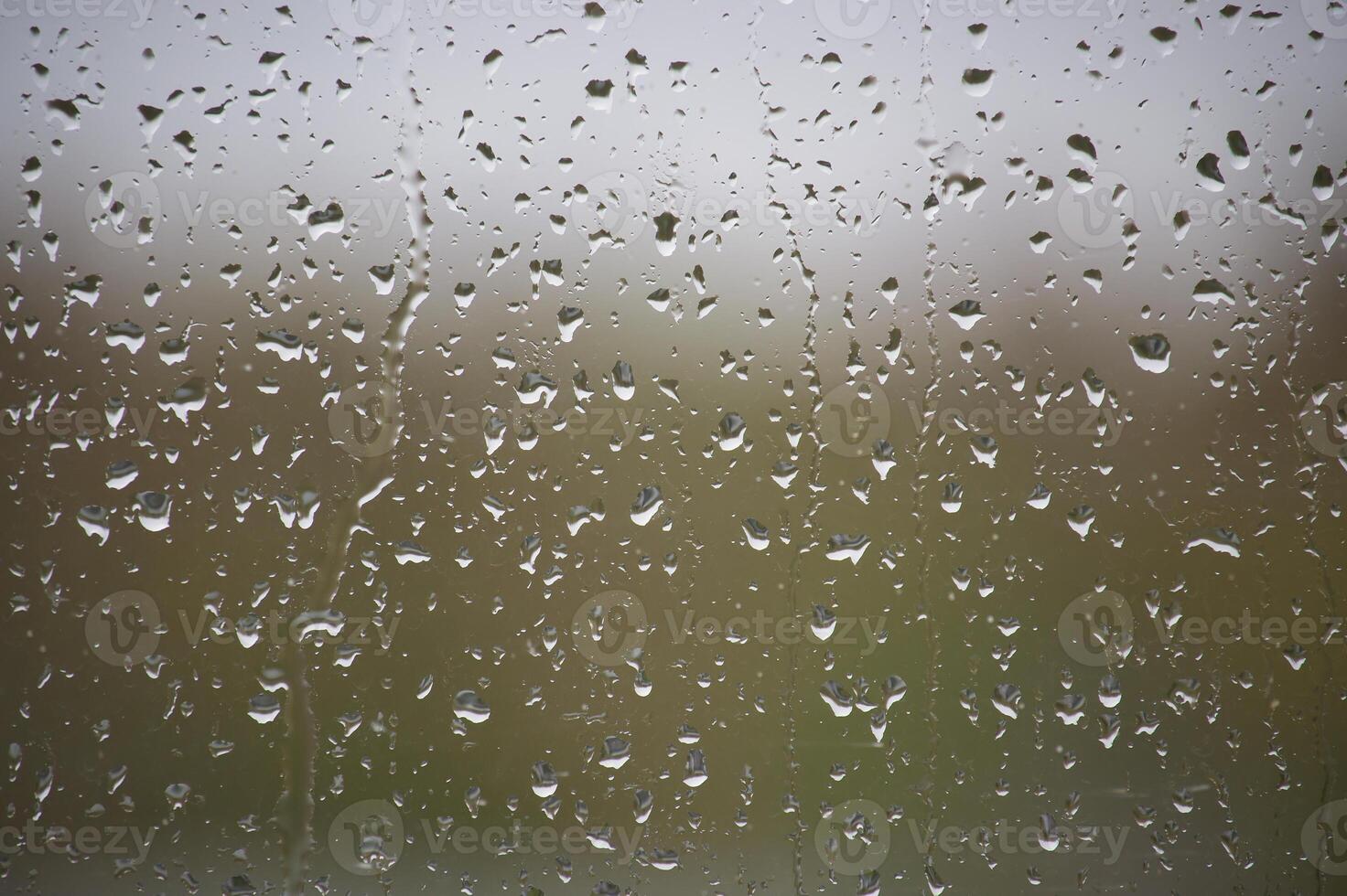 Window glass surface covered by water droplets photo