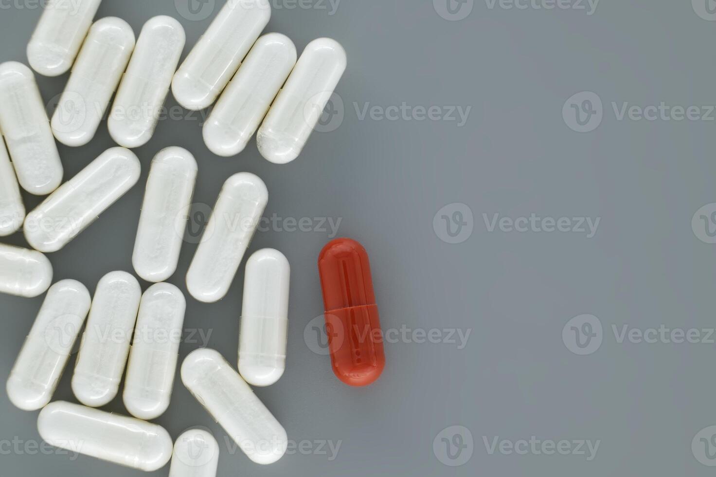 Medical pills scattered on a gray surface photo