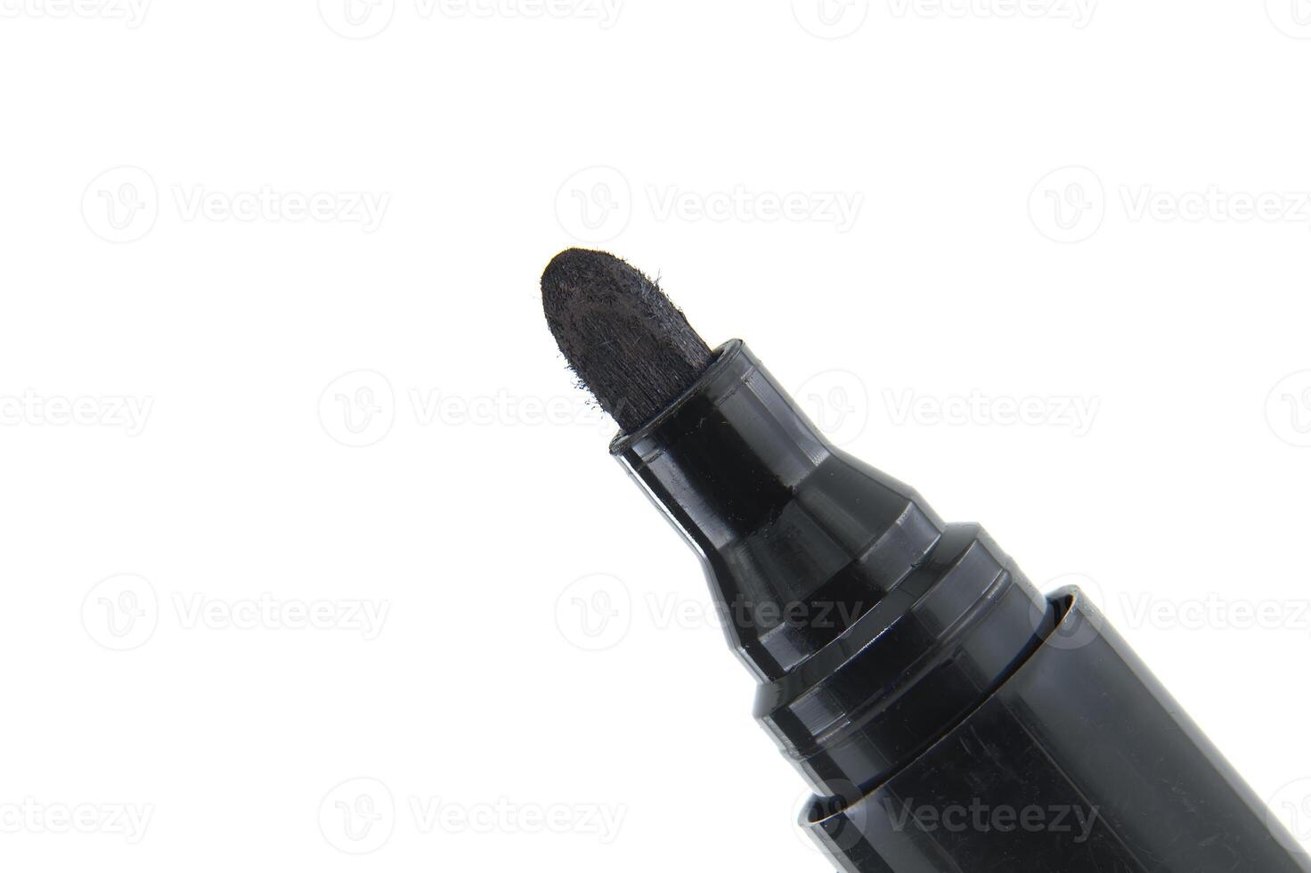 Close-up of black permanent marker with white background for office and art use photo
