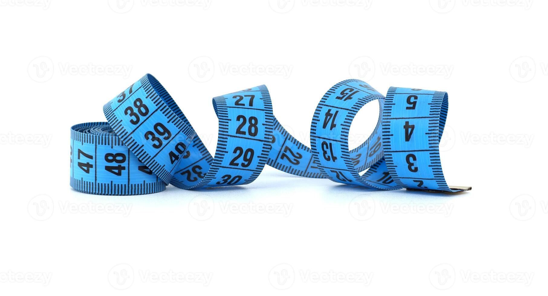 Blue measuring tape curled on white background representing fitness and precision photo
