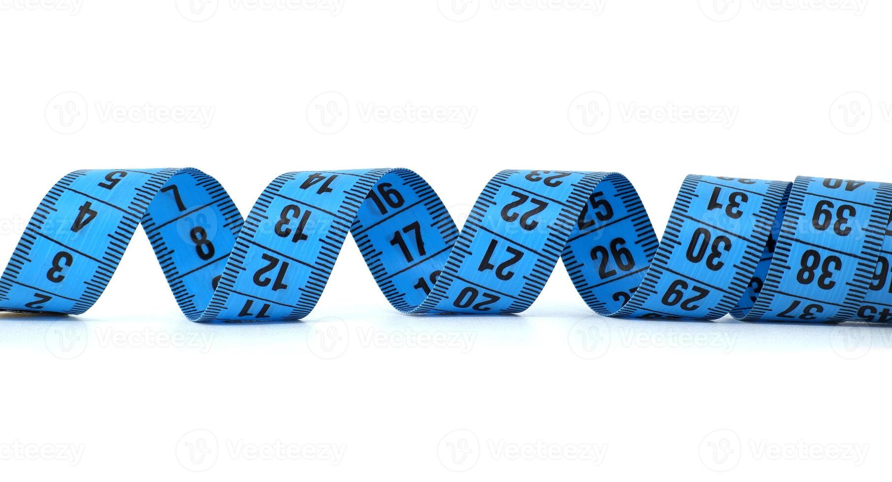 Close-up of blue measuring tape isolated on white background showcasing numbers photo
