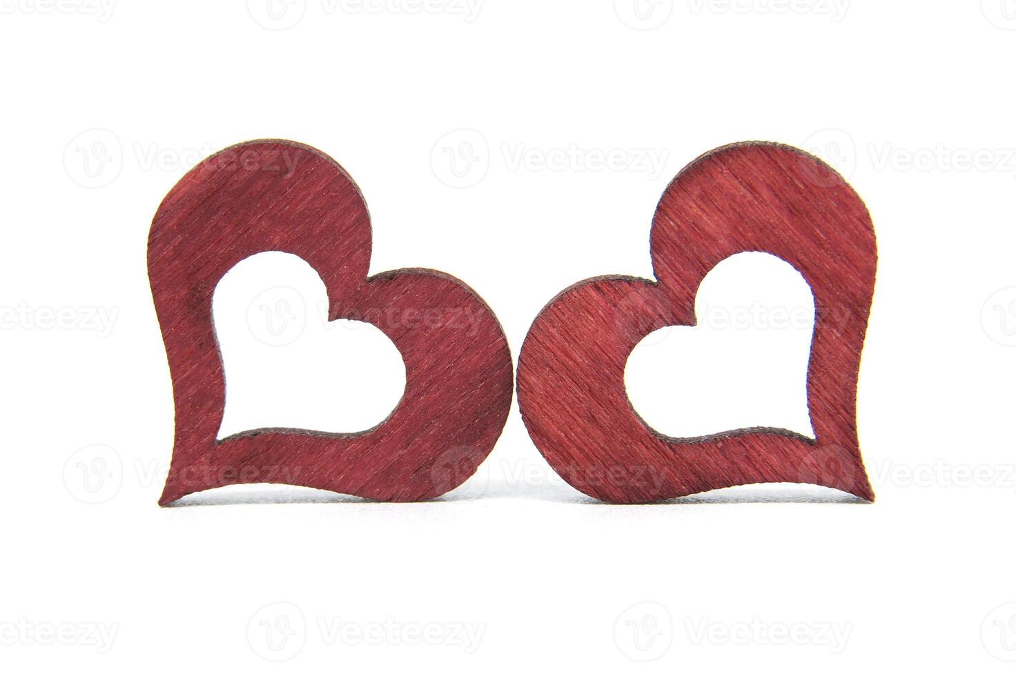 Close-up of two red wooden heart shapes symbolizing love and romance photo