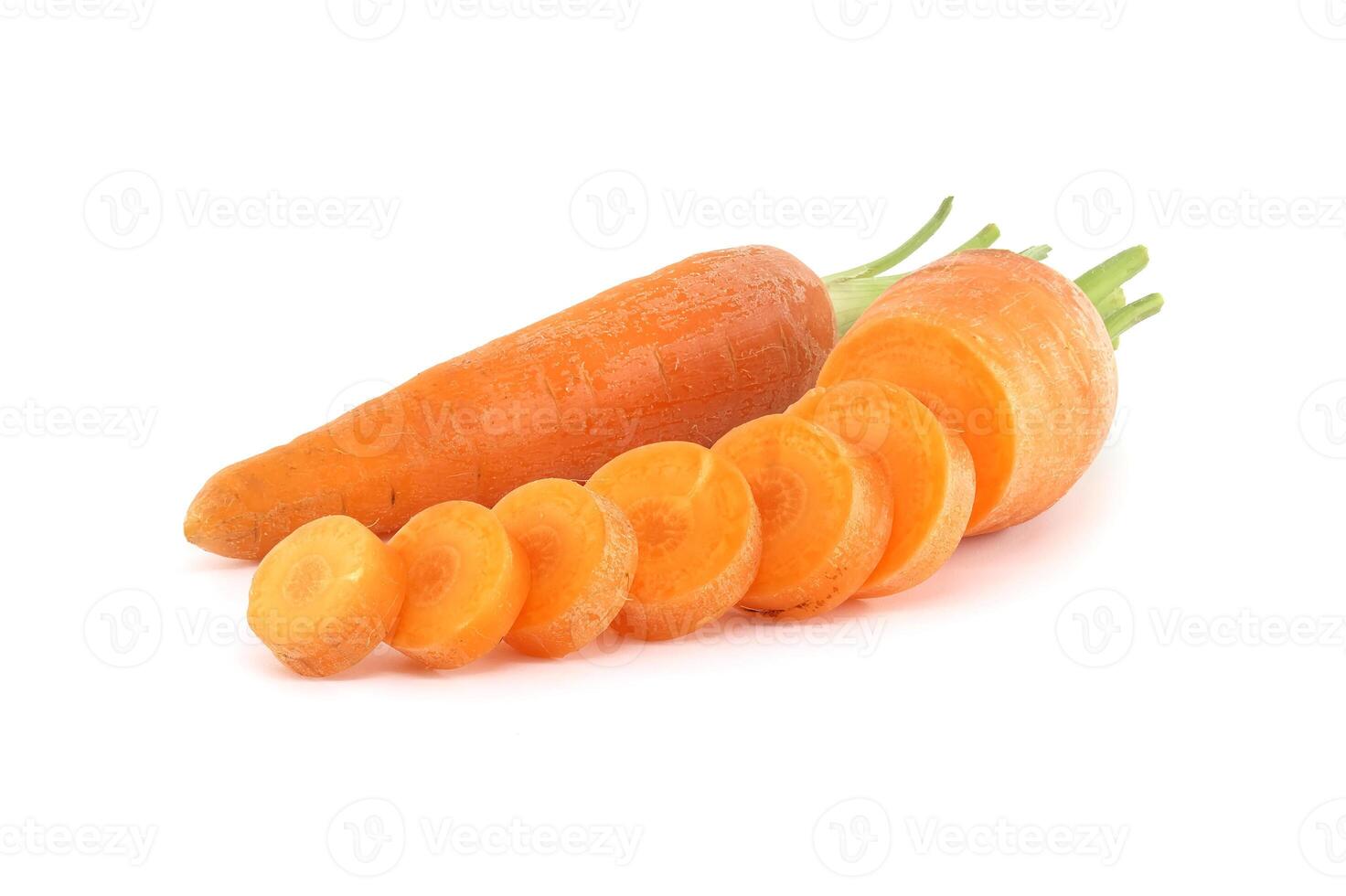 Whole carrot and its sliced pieces isolated against a white background photo
