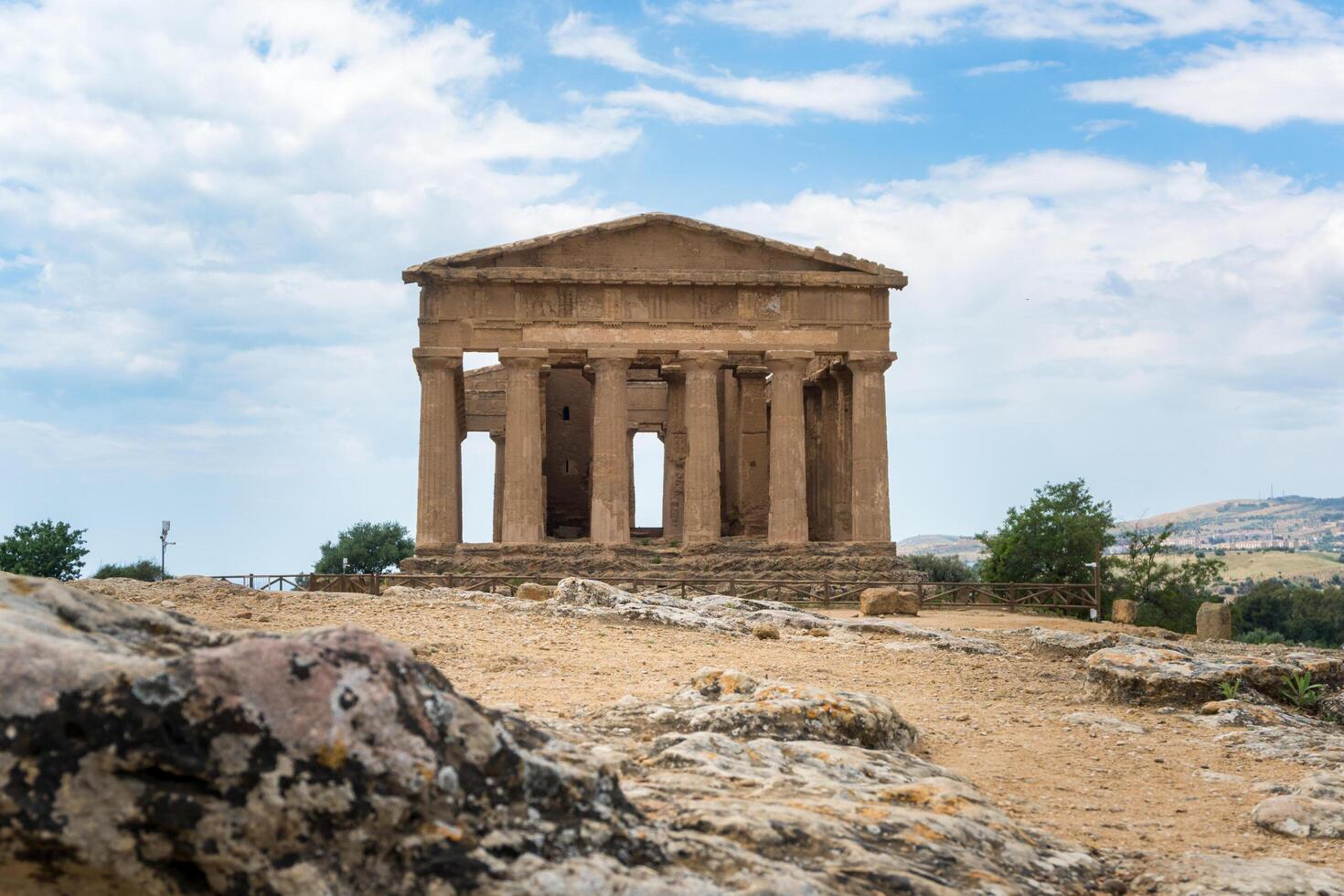 Agrigento, Italy-May 10, 2022-people near the Temple of Concordia inside the valley of the temples, an archaeological park near Agrigento during a sunny day photo