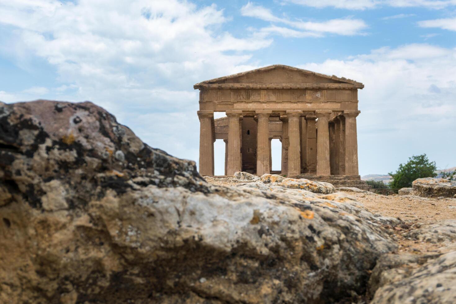 Agrigento, Italy-May 10, 2022-people near the Temple of Concordia inside the valley of the temples, an archaeological park near Agrigento during a sunny day photo