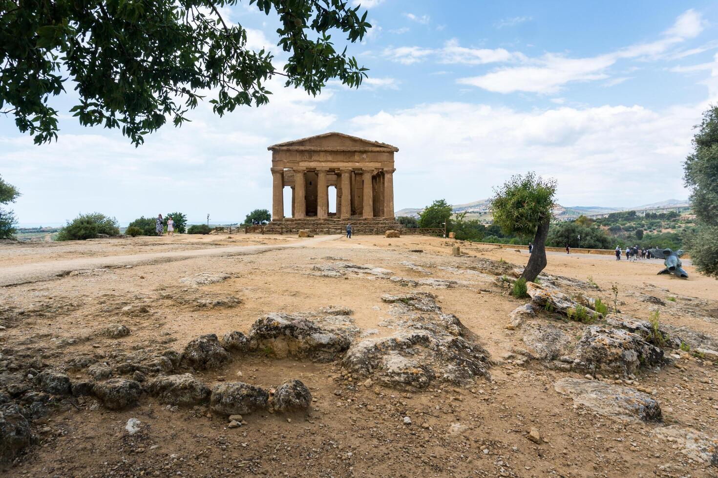 Agrigento, Italy-May 10, 2022-people near the Temple of Concordia inside the valley of the temples, an archaeological park near Agrigento during a sunny day photo