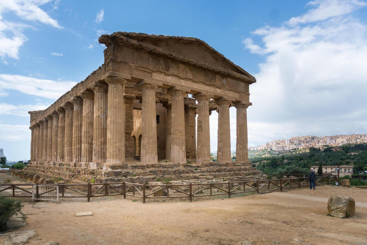 Agrigento, Italy-May 10, 2022-people near the Temple of Concordia inside the valley of the temples, an archaeological park near Agrigento during a sunny day photo
