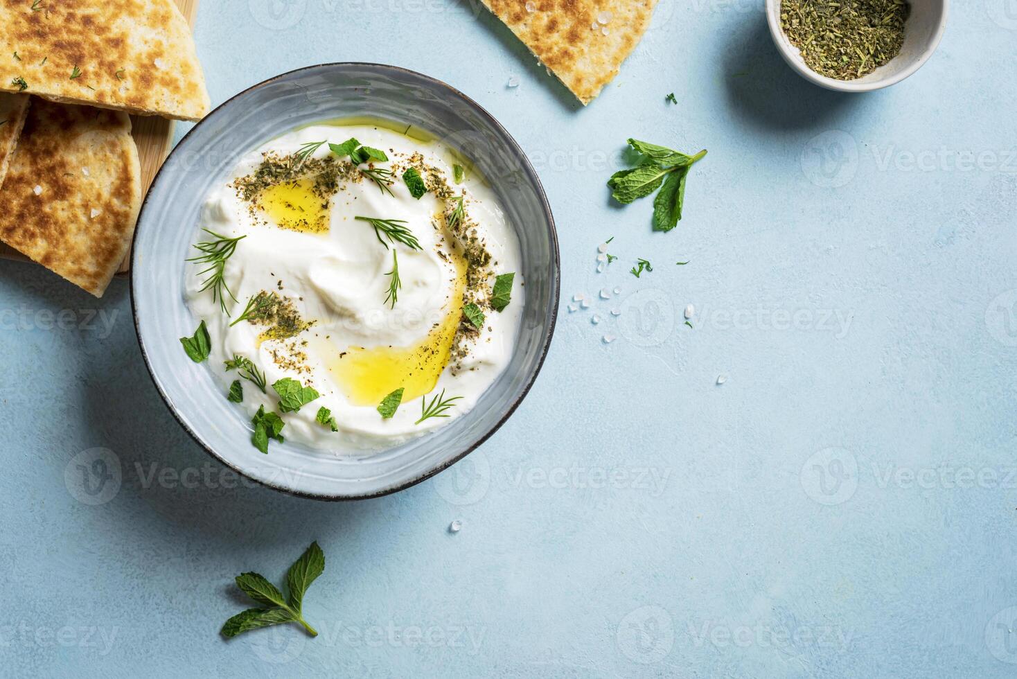 Labneh yogurt cream cheese dip with pita bread photo