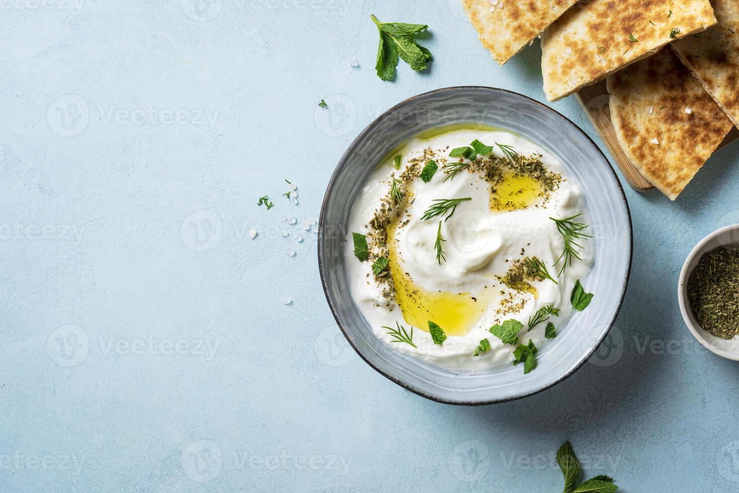Labneh yogurt cream cheese dip with pita bread photo