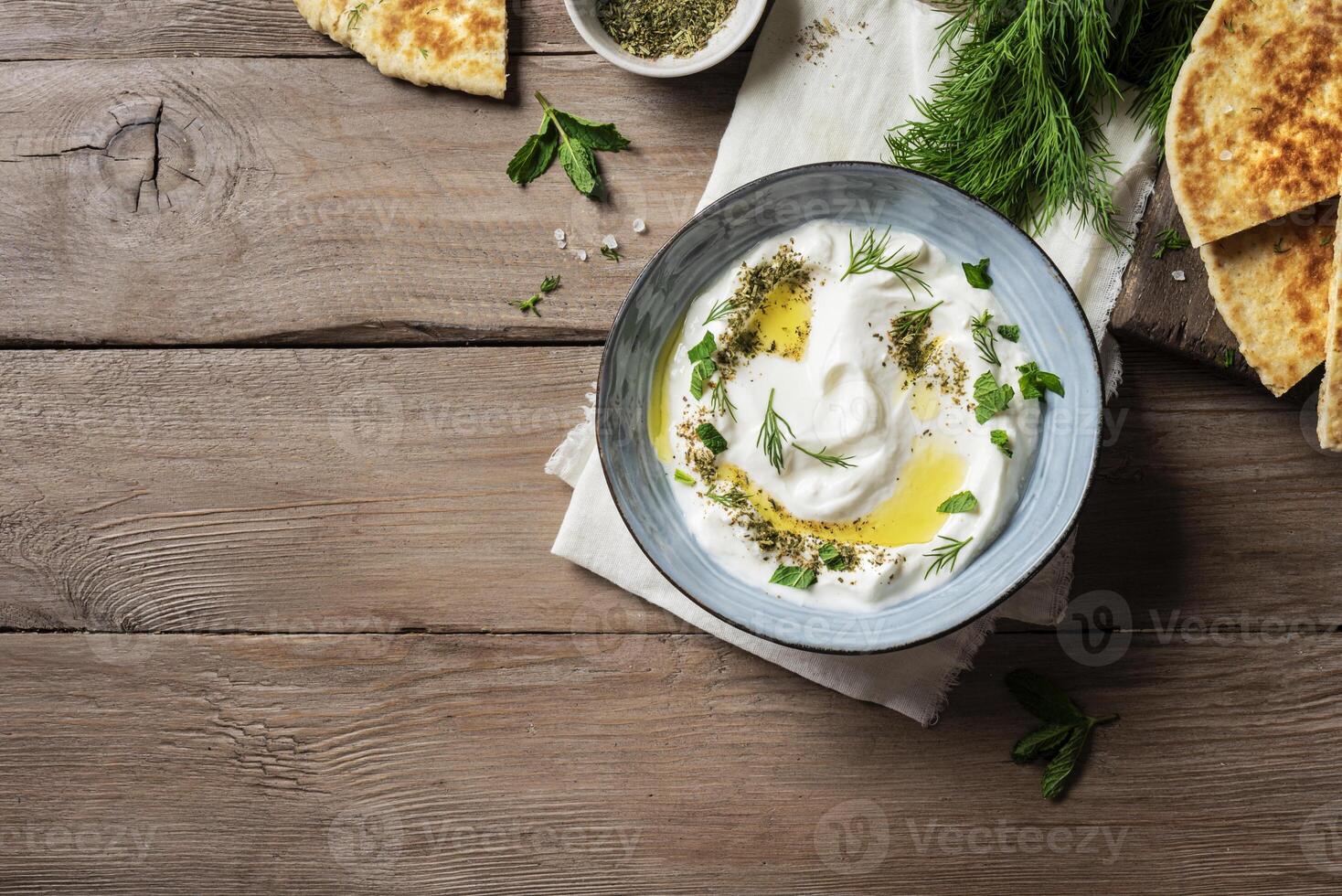 Labneh yogurt cream cheese dip with pita bread photo