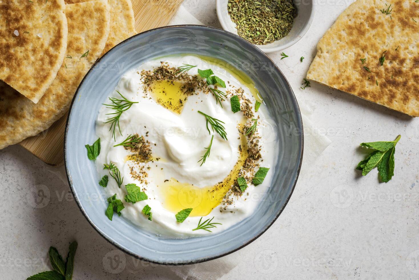 Labneh yogurt cream cheese dip with pita bread photo