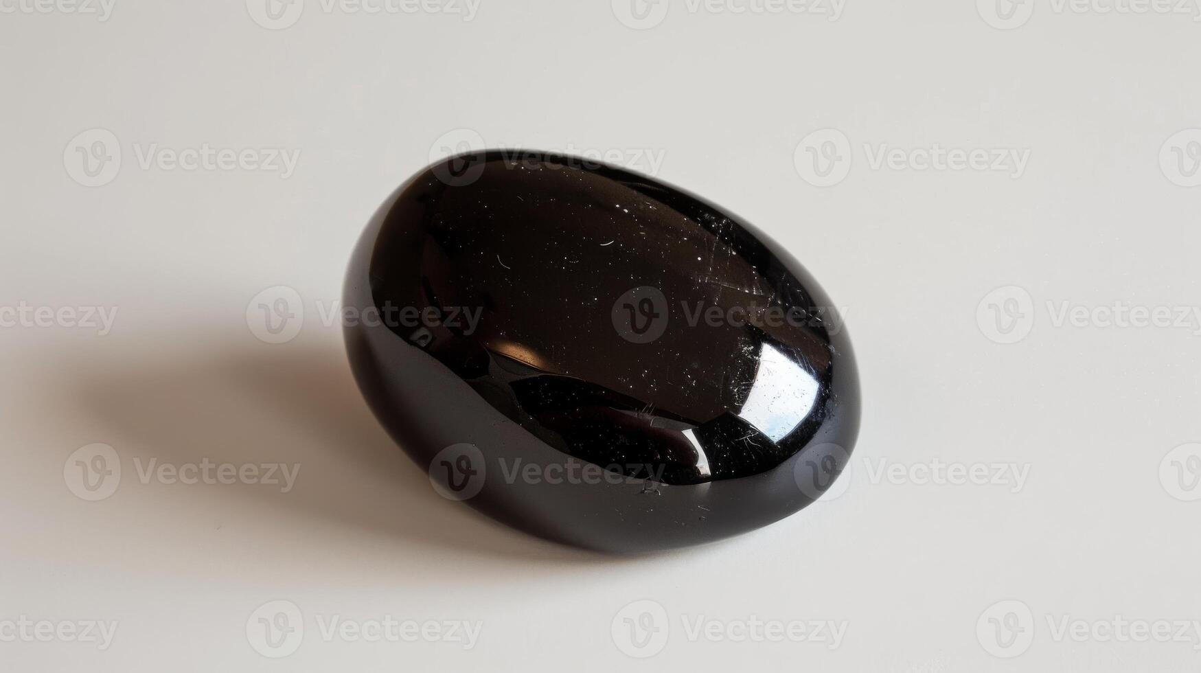 Polished Black Tourmaline Stone on Plain White Background for Crystal Healing and Mineral Collecting Design photo