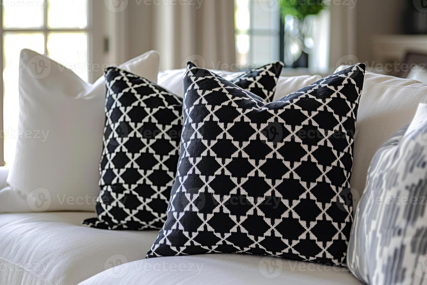 A cozy living room setup featuring a white sofa adorned with pillows photo