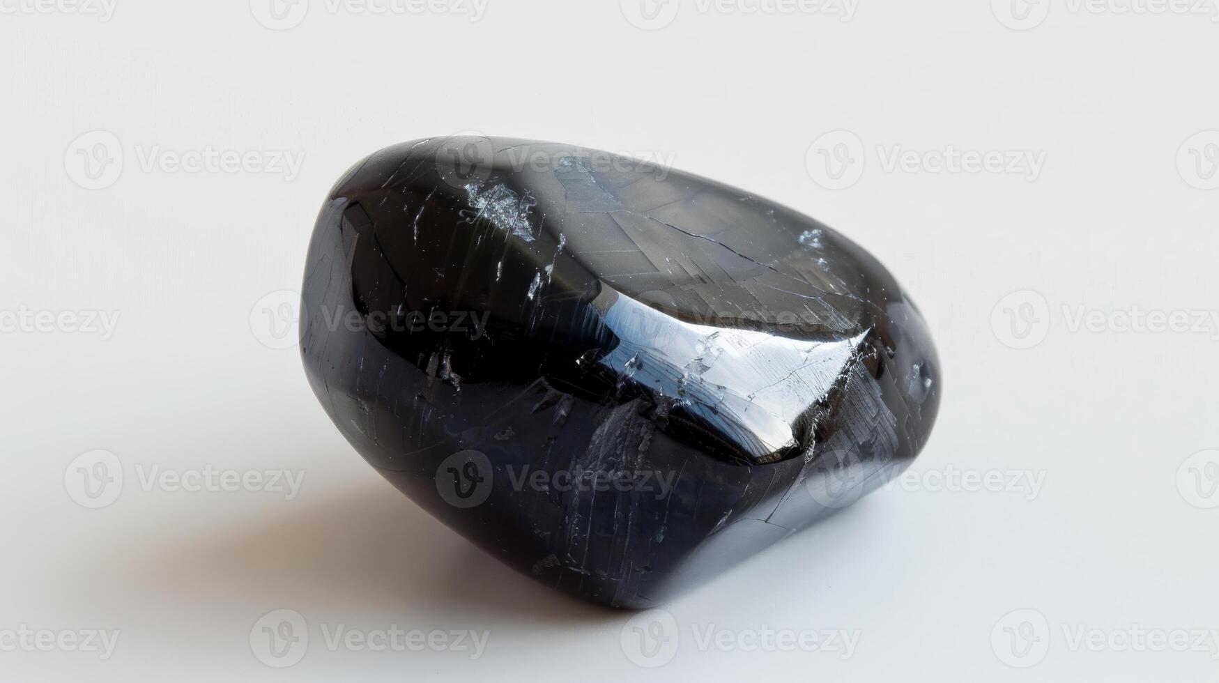 CloseUp of a Single Polished Black Tourmaline Stone on a White Background for Geology, Mineral Collection, and Crystal Healing photo