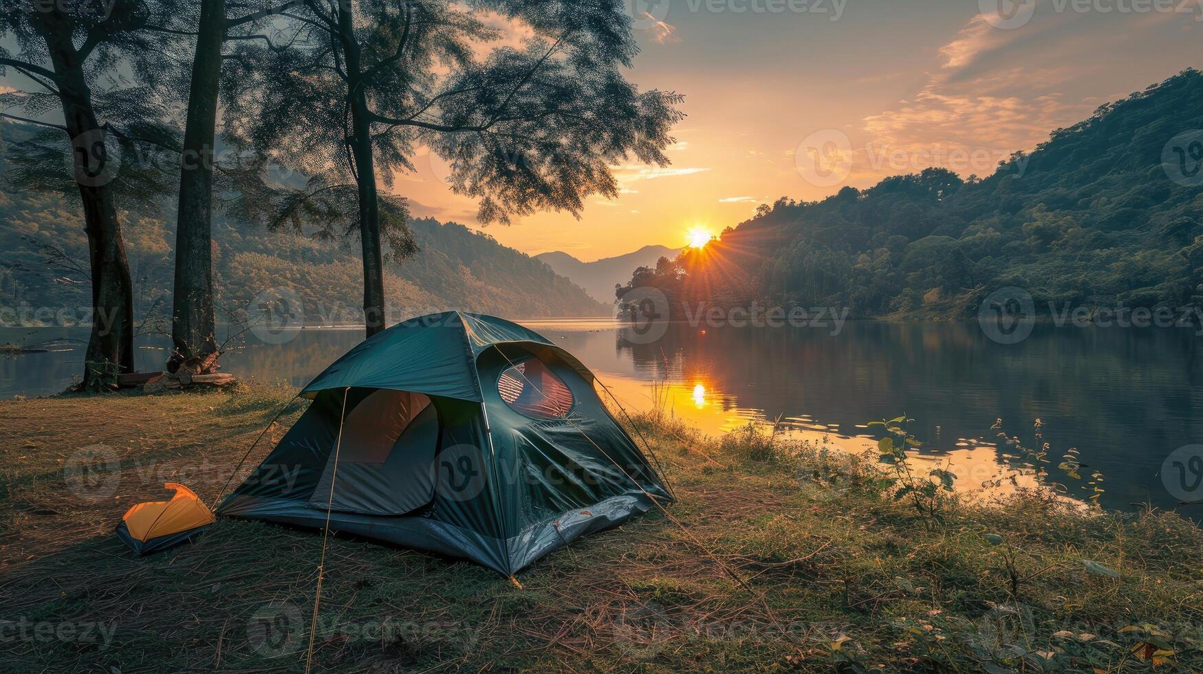 A green tent by the river during sunset surrounded by lush foliage, representing tranquility, nature, and the serene outdoor experience. photo