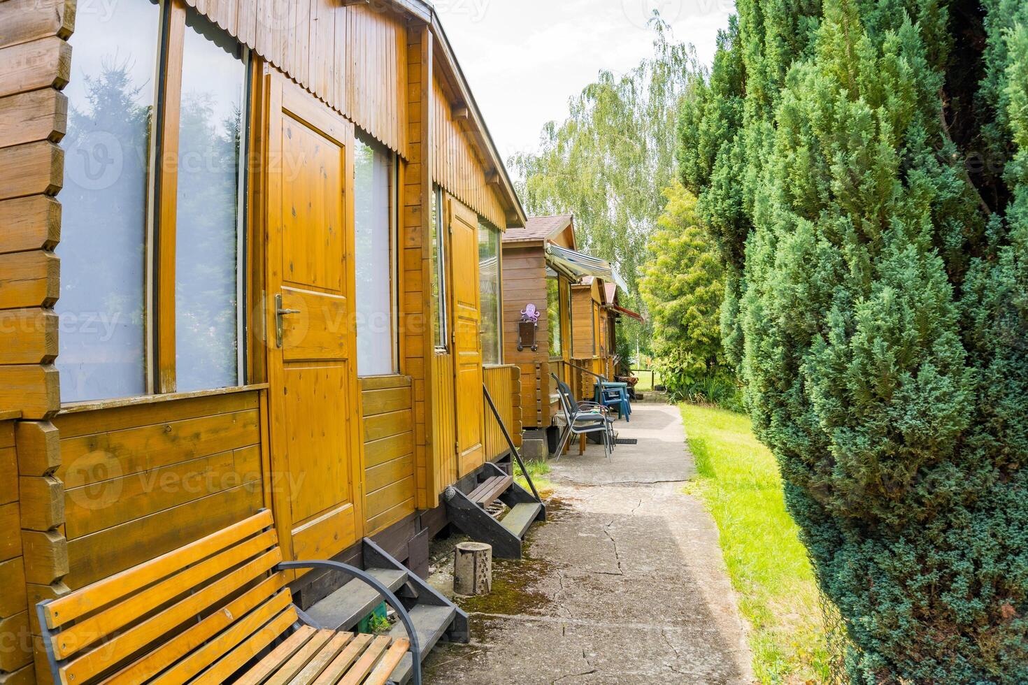 Camping house, row of small wooden huts or houses on green valley. Zadni Treban photo