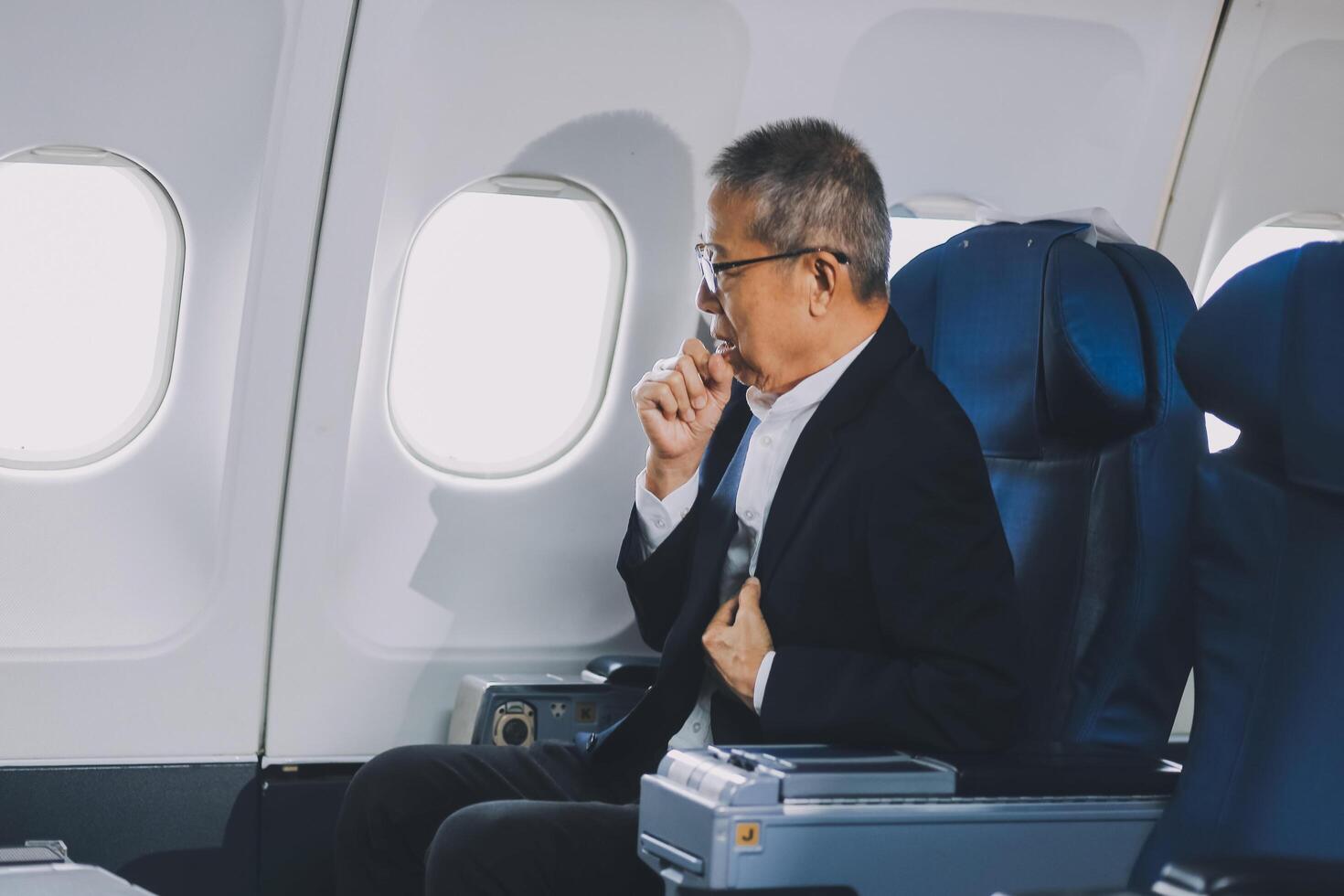 headache in the airplane, man passenger afraid and feeling bad during the flight in plane photo