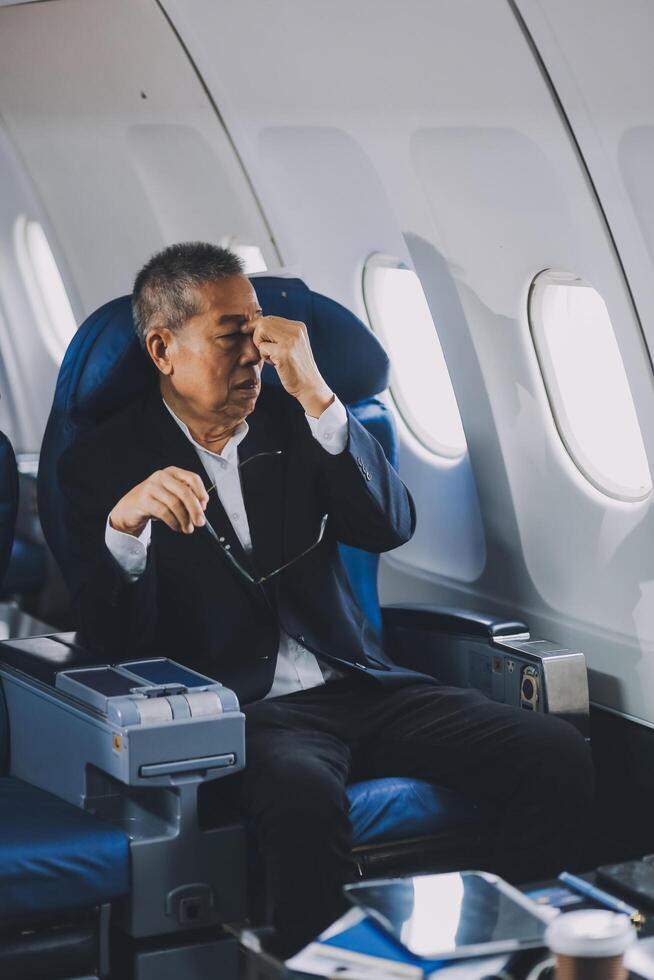 headache in the airplane, man passenger afraid and feeling bad during the flight in plane photo