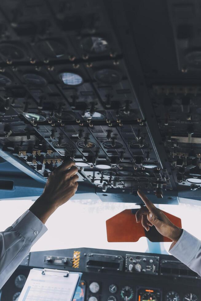 Professional pilot woman in uniform has teamwork meeting for success flight in aviation business. Young female captain instructor sitting in office and working or training commercial airline crew. photo