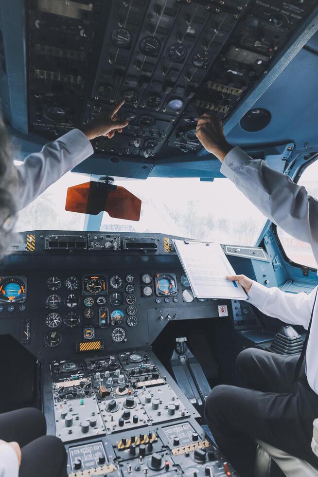 Professional pilot woman in uniform has teamwork meeting for success flight in aviation business. Young female captain instructor sitting in office and working or training commercial airline crew. photo