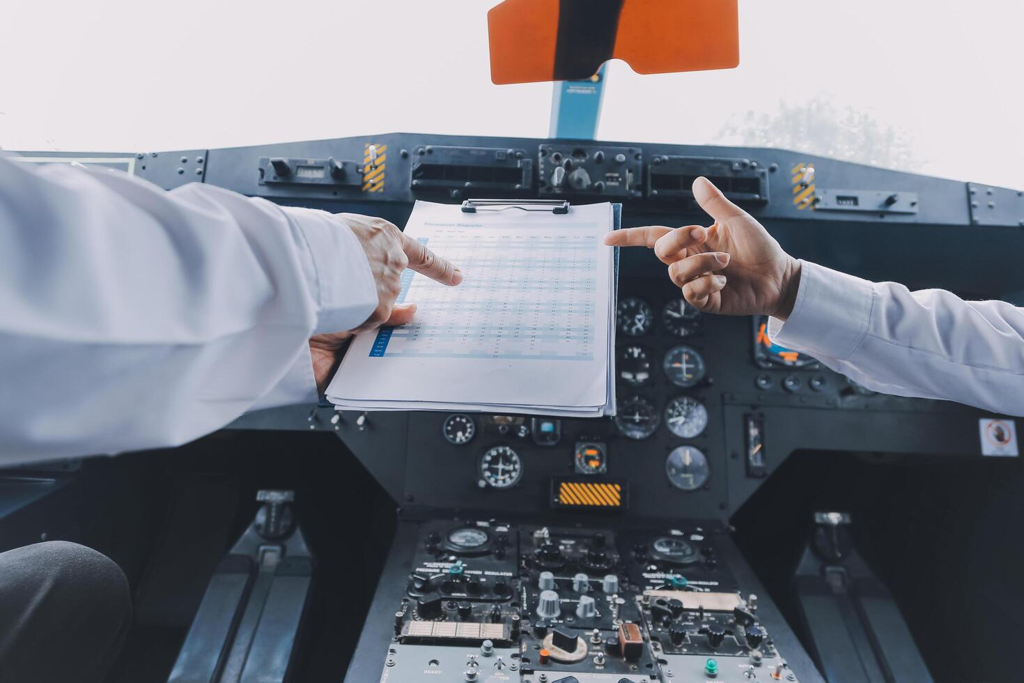 Professional pilot woman in uniform has teamwork meeting for success flight in aviation business. Young female captain instructor sitting in office and working or training commercial airline crew. photo