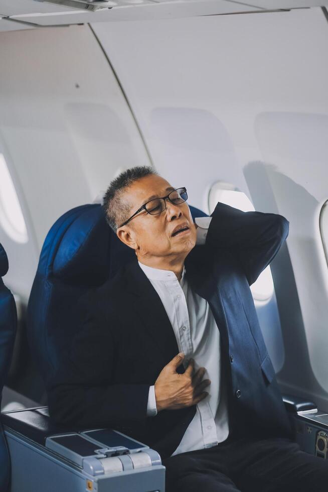 headache in the airplane, man passenger afraid and feeling bad during the flight in plane photo