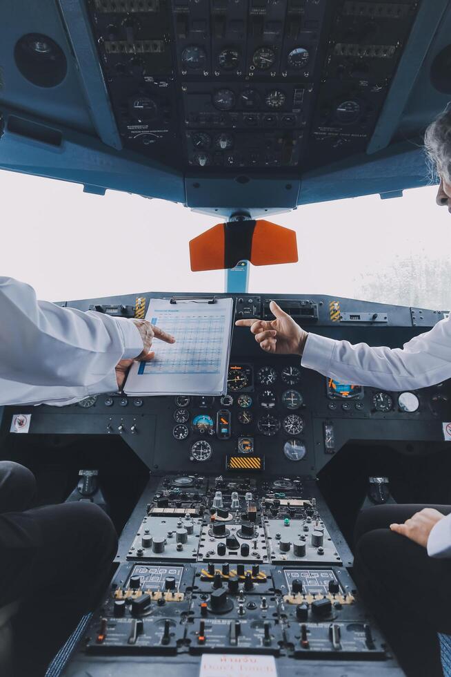 Professional pilot woman in uniform has teamwork meeting for success flight in aviation business. Young female captain instructor sitting in office and working or training commercial airline crew. photo