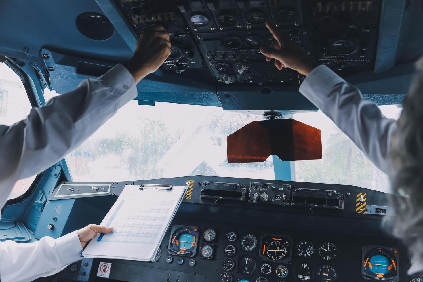 Professional pilot woman in uniform has teamwork meeting for success flight in aviation business. Young female captain instructor sitting in office and working or training commercial airline crew. photo