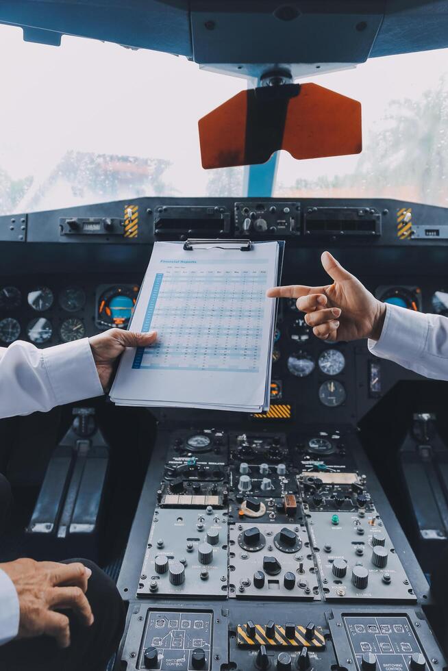 Professional pilot woman in uniform has teamwork meeting for success flight in aviation business. Young female captain instructor sitting in office and working or training commercial airline crew. photo
