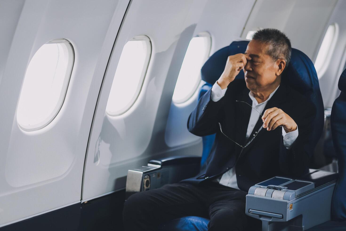 headache in the airplane, man passenger afraid and feeling bad during the flight in plane photo