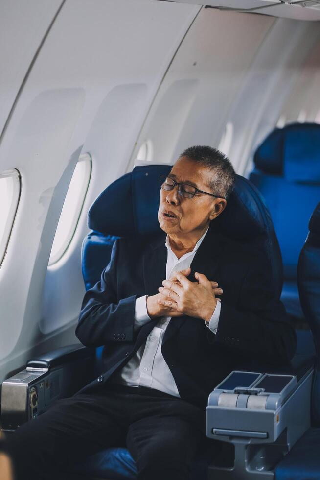 headache in the airplane, man passenger afraid and feeling bad during the flight in plane photo