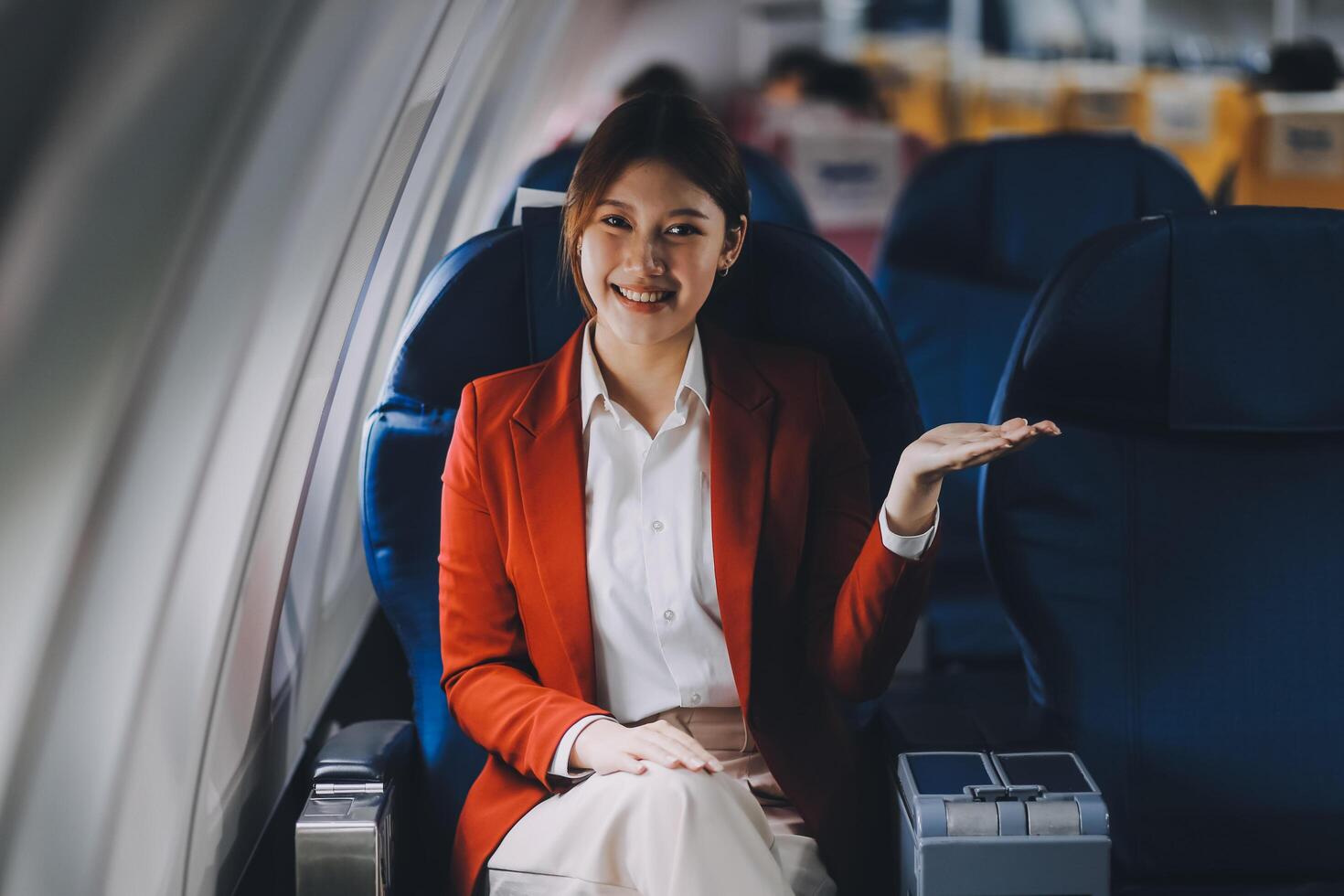 A young Asian woman, seated as an airplane passenger, contemplates dollar bills, reflecting on lucrative opportunities and aspirations towards billionaire status. photo