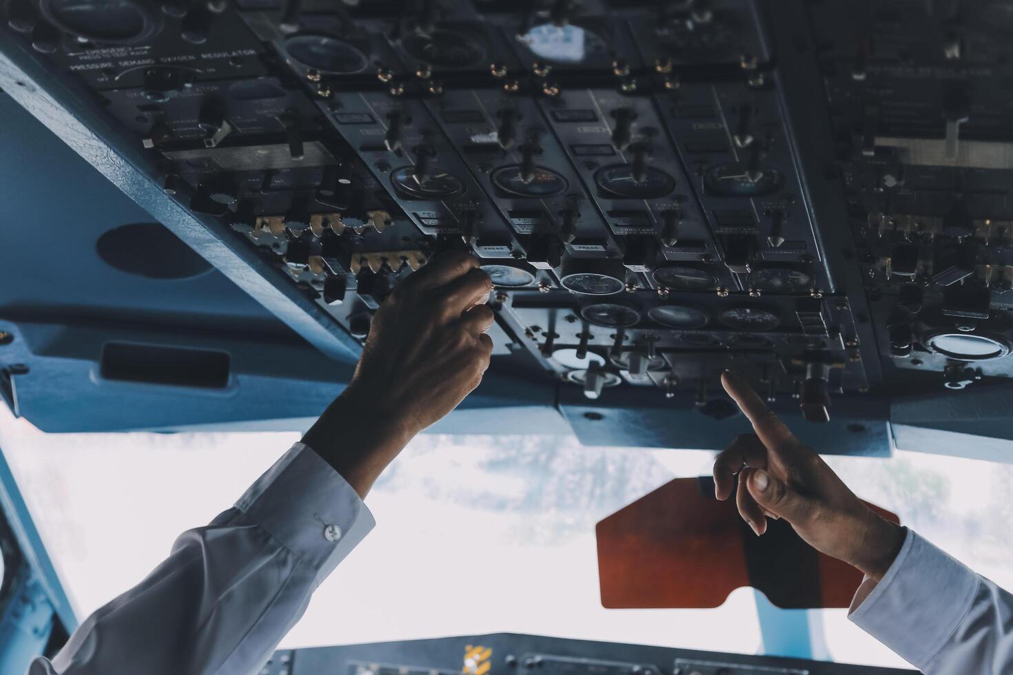 Professional pilot woman in uniform has teamwork meeting for success flight in aviation business. Young female captain instructor sitting in office and working or training commercial airline crew. photo