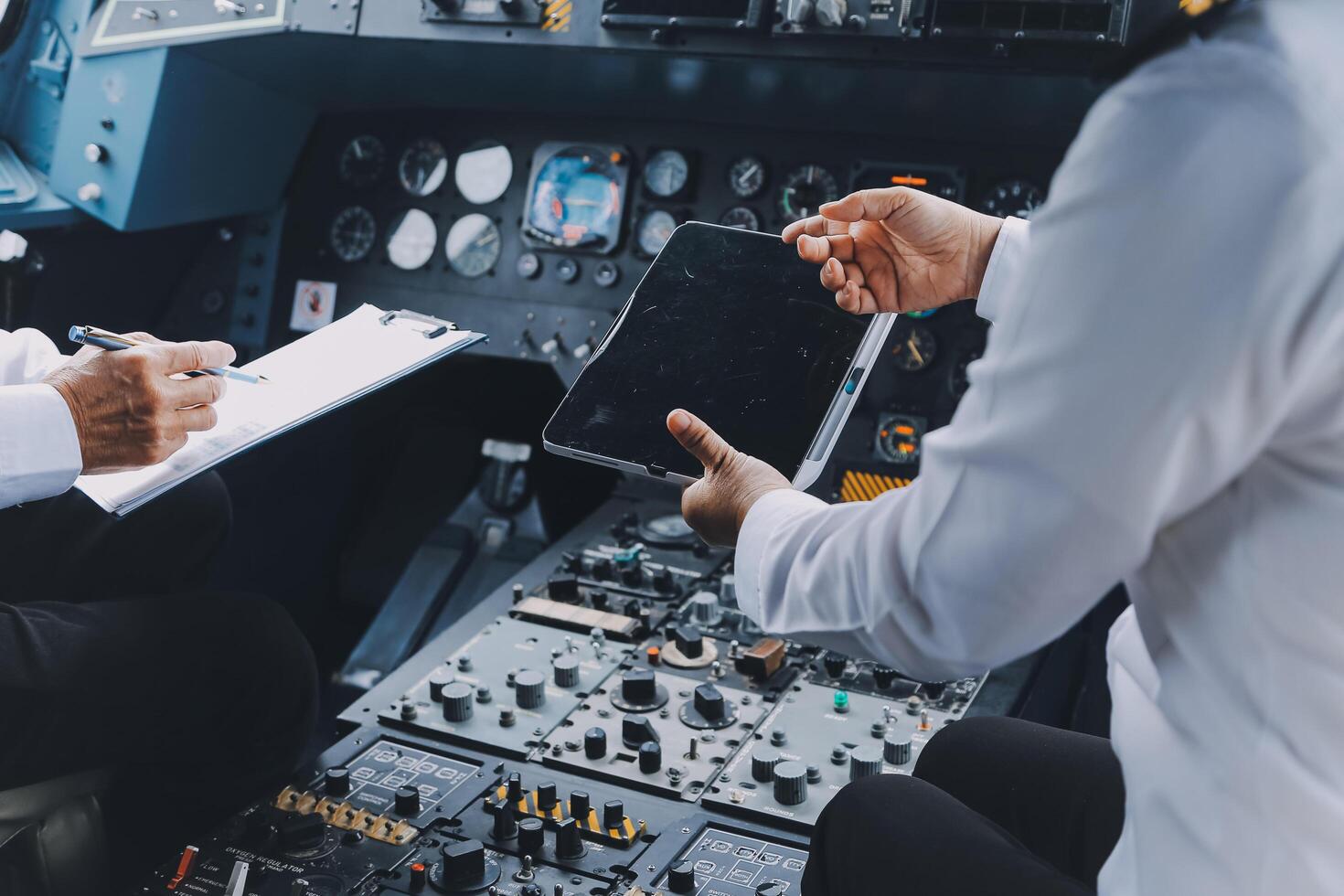 Professional pilot woman in uniform has teamwork meeting for success flight in aviation business. Young female captain instructor sitting in office and working or training commercial airline crew. photo