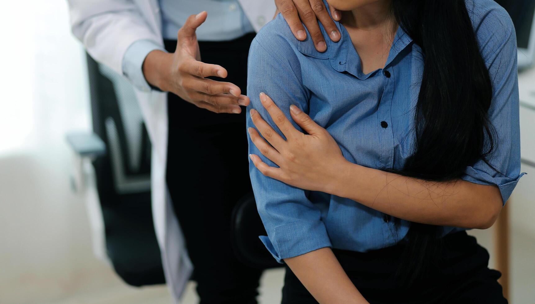Doctor or Physiotherapist working examining treating injured arm of athlete male patient, stretching and exercise, Doing the Rehabilitation therapy pain in clinic. photo