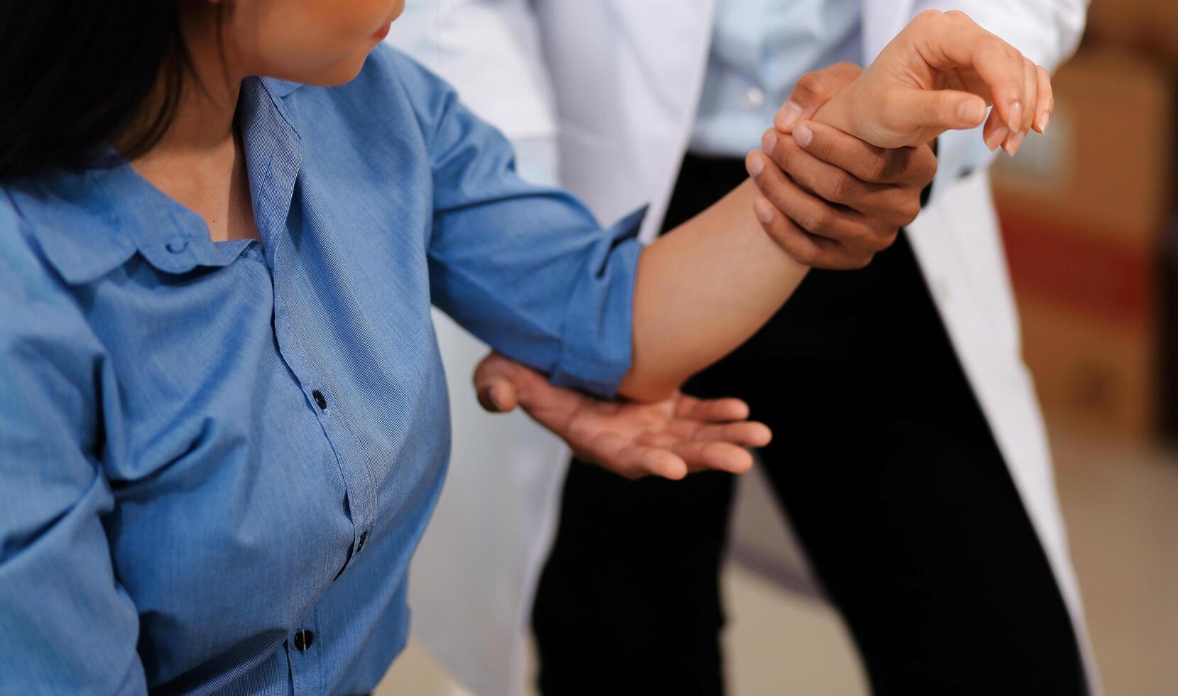 Doctor or Physiotherapist working examining treating injured arm of athlete male patient, stretching and exercise, Doing the Rehabilitation therapy pain in clinic. photo