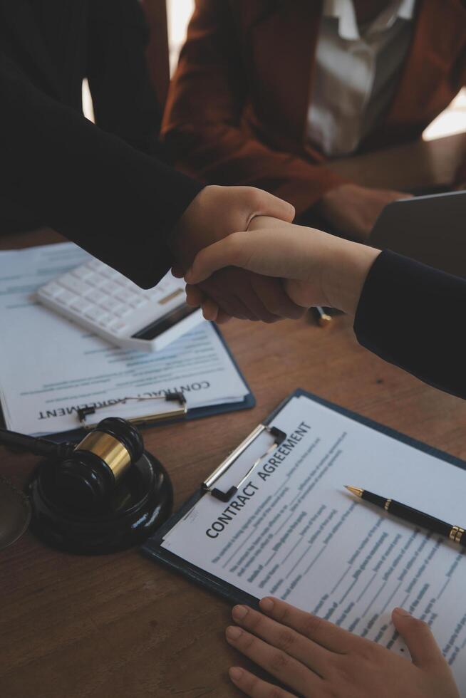 concept of justice and law A male judge in the courtroom on a wooden table and a male counselor or lawyer working in the office. Law, advice and justice concepts. photo