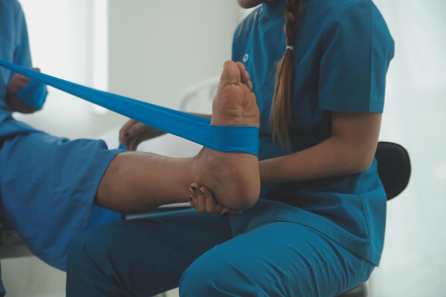 Physical therapists work with patients in close-up clinics. The concept of rehabilitation of physical health, the doctor gives advice to the patient. Ankle problems and muscle injuries photo