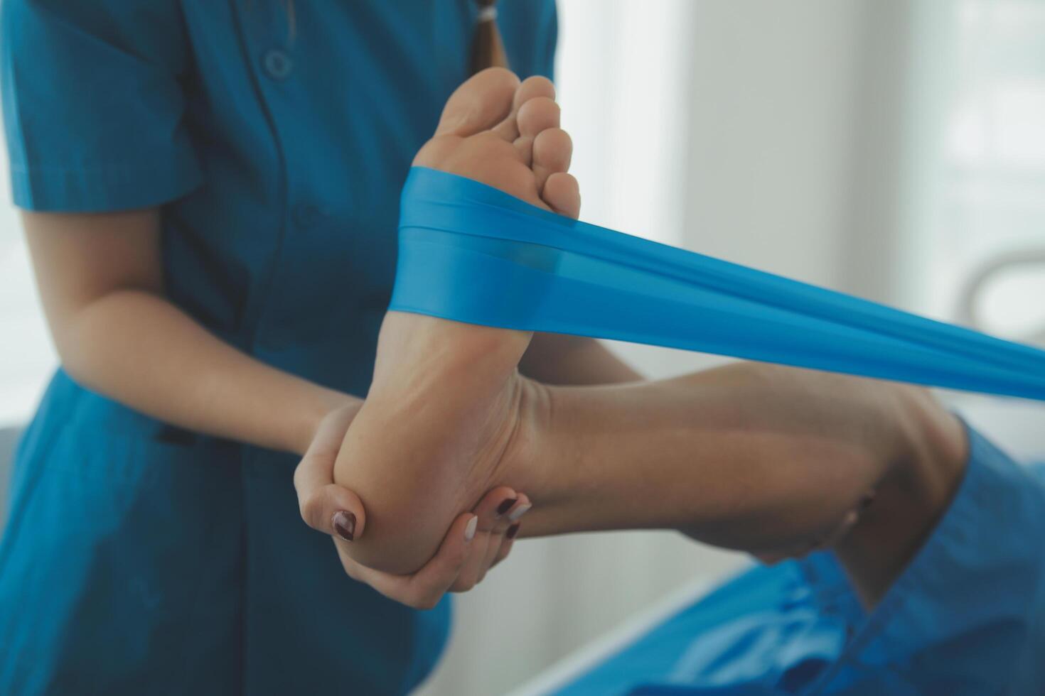Physical therapists work with patients in close-up clinics. The concept of rehabilitation of physical health, the doctor gives advice to the patient. Ankle problems and muscle injuries photo