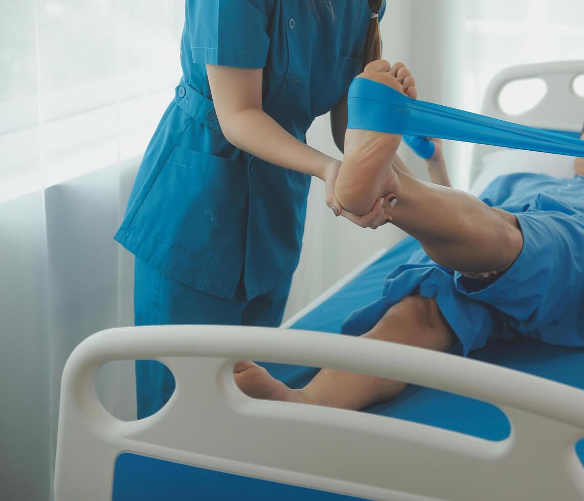 Physical therapists work with patients in close-up clinics. The concept of rehabilitation of physical health, the doctor gives advice to the patient. Ankle problems and muscle injuries photo