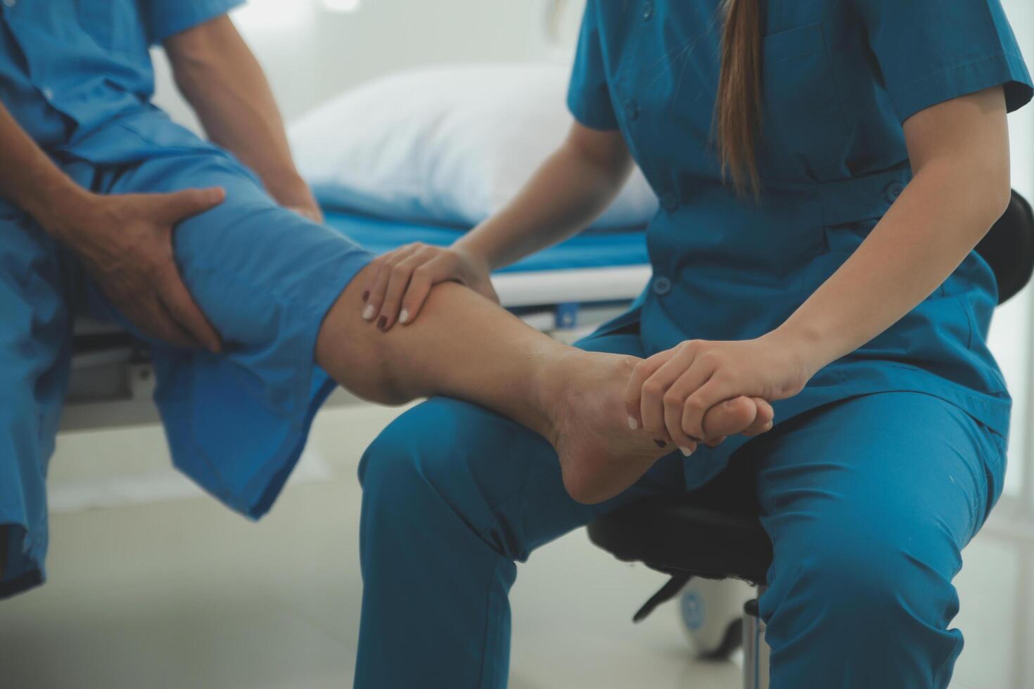 Physical therapists work with patients in close-up clinics. The concept of rehabilitation of physical health, the doctor gives advice to the patient. Ankle problems and muscle injuries photo