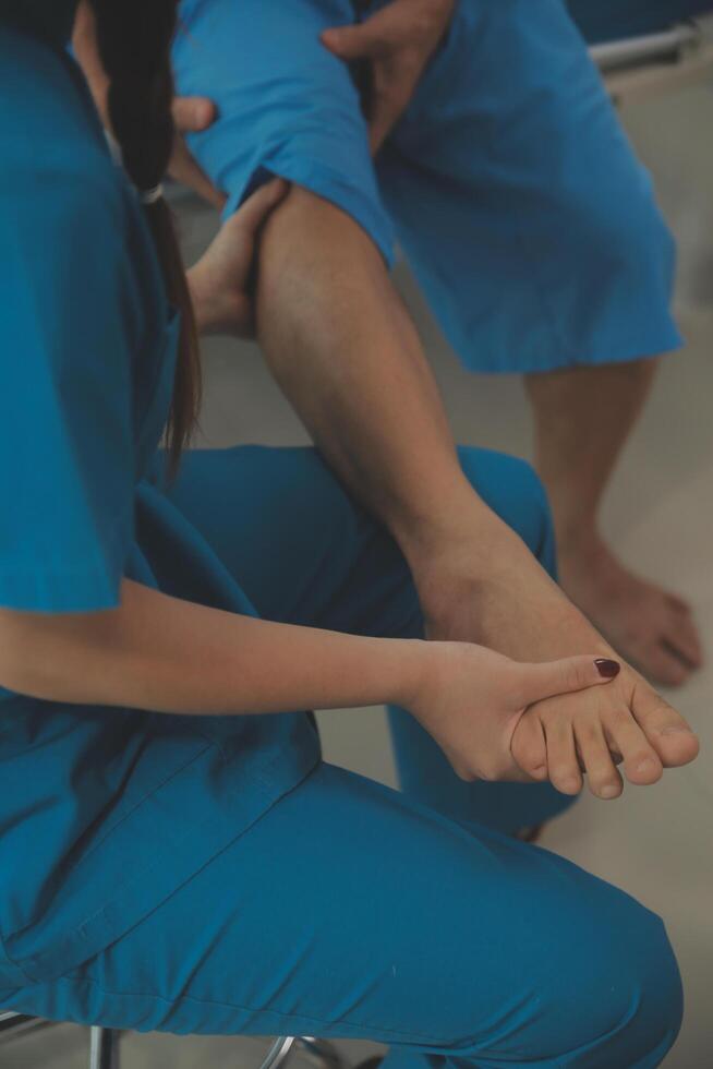 Physical therapists work with patients in close-up clinics. The concept of rehabilitation of physical health, the doctor gives advice to the patient. Ankle problems and muscle injuries photo
