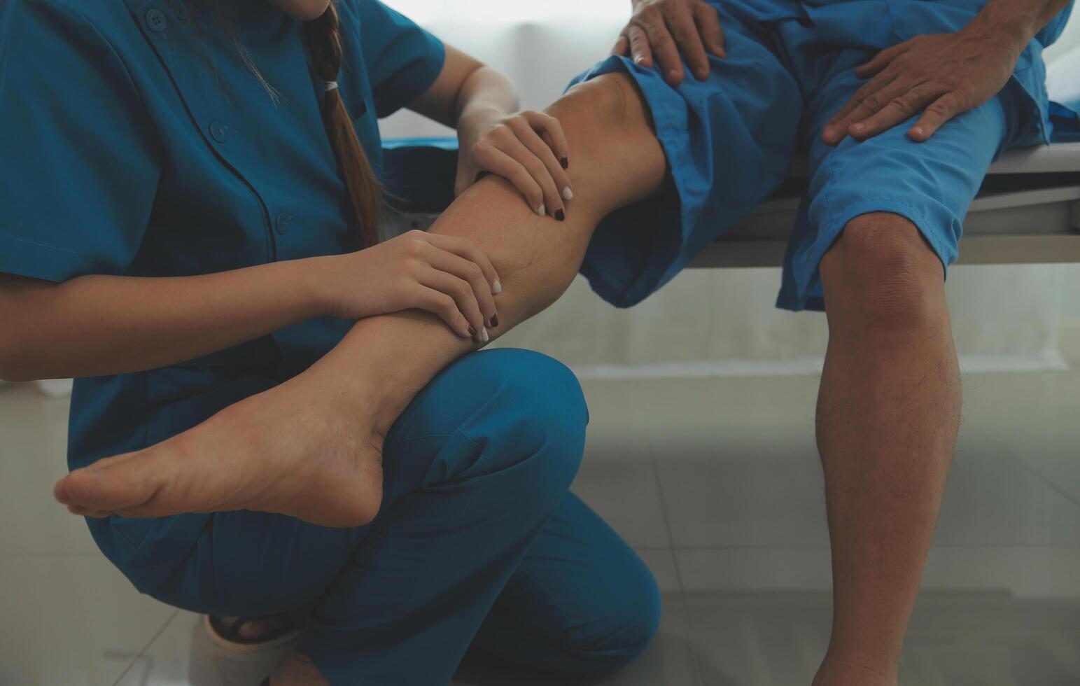 Physical therapists work with patients in close-up clinics. The concept of rehabilitation of physical health, the doctor gives advice to the patient. Ankle problems and muscle injuries photo